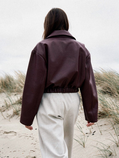 Burgundy faux leather jacket seen from behind, boxy oversized cut