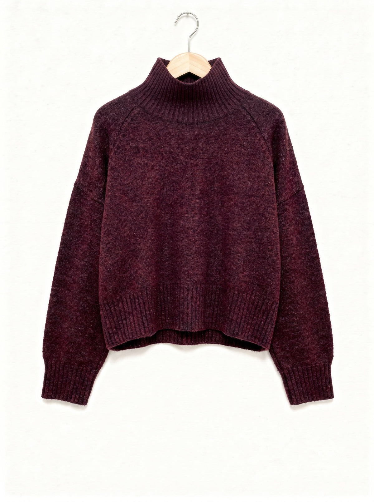 Burgundy jumper in claret, ribbed funnel neck and raglan sleeves, shown on a wooden hanger