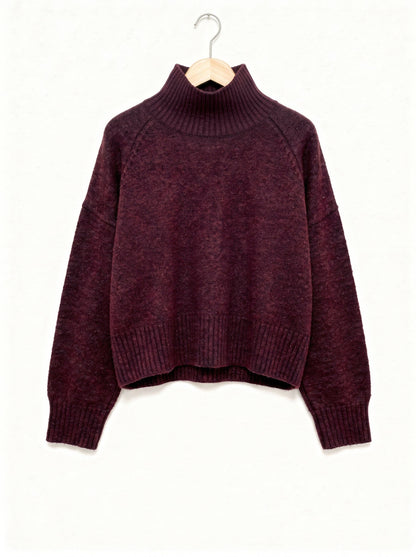 Burgundy jumper in claret, ribbed funnel neck and raglan sleeves, shown on a wooden hanger