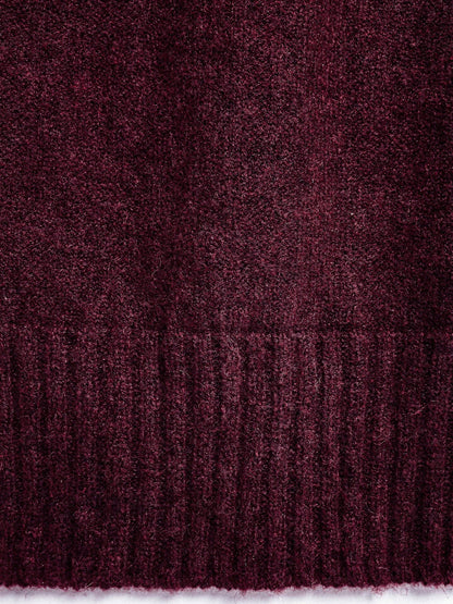 Close-up of the brushed marl knit and the deep ribbed hem of the burgundy jumper
