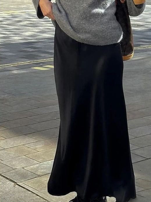 The black satin skirt worn in the street, a real photograph from the maker showing the skirt from the waistband to the hem
