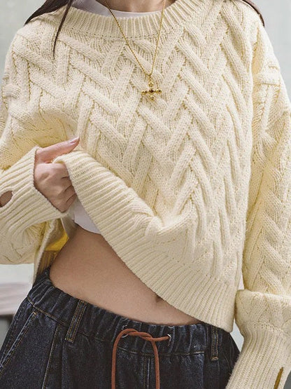 Cropped cable knit jumper in Shortbread cream worn with wide jeans