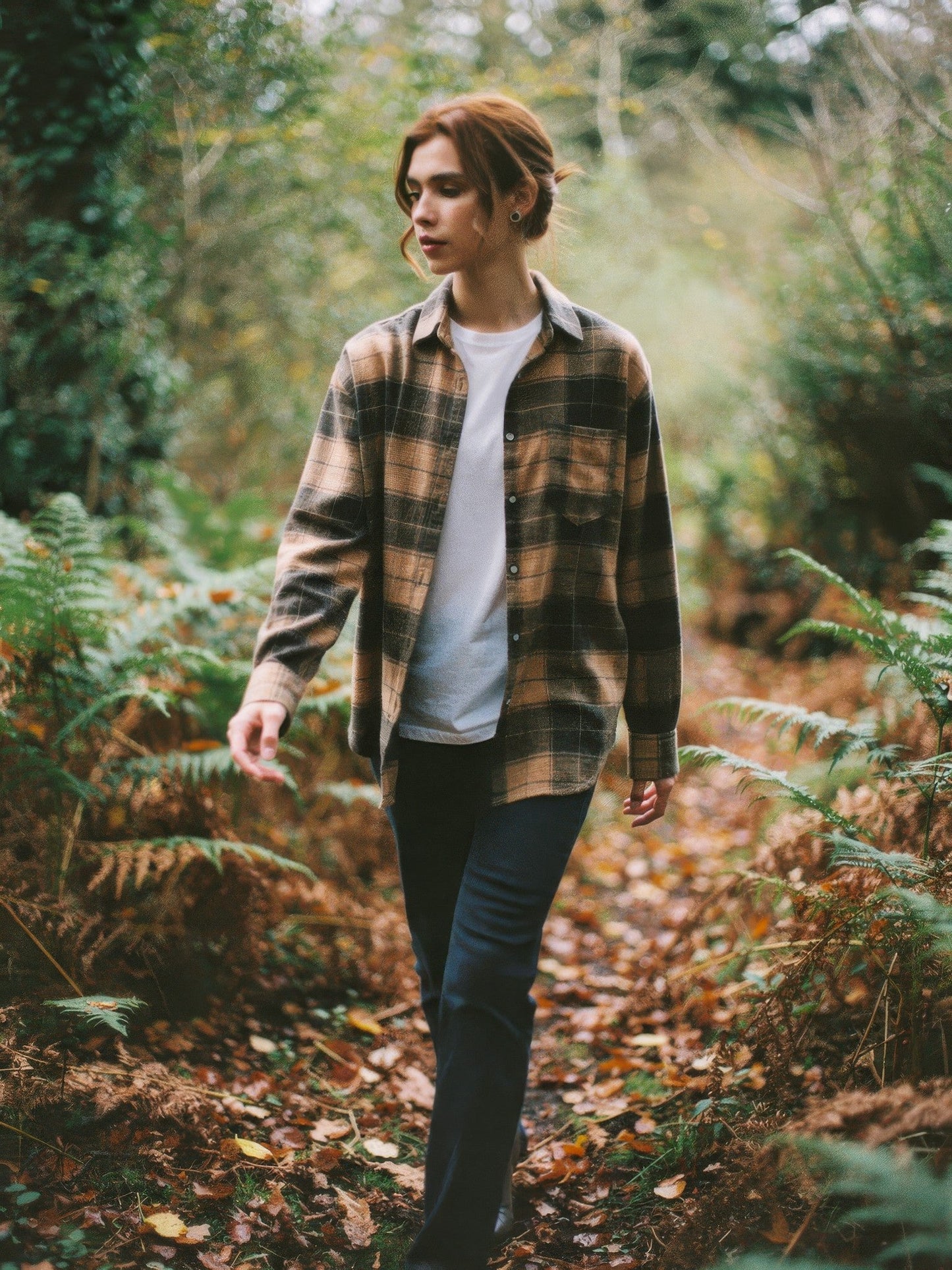 Woman wearing a camel check flannel overshirt in autumn woodland
