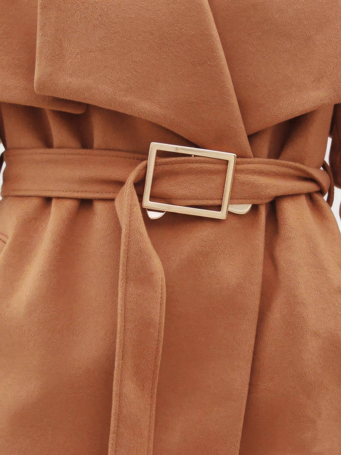 Close up of the self fabric belt and squared gold tone buckle on a camel wrap coat