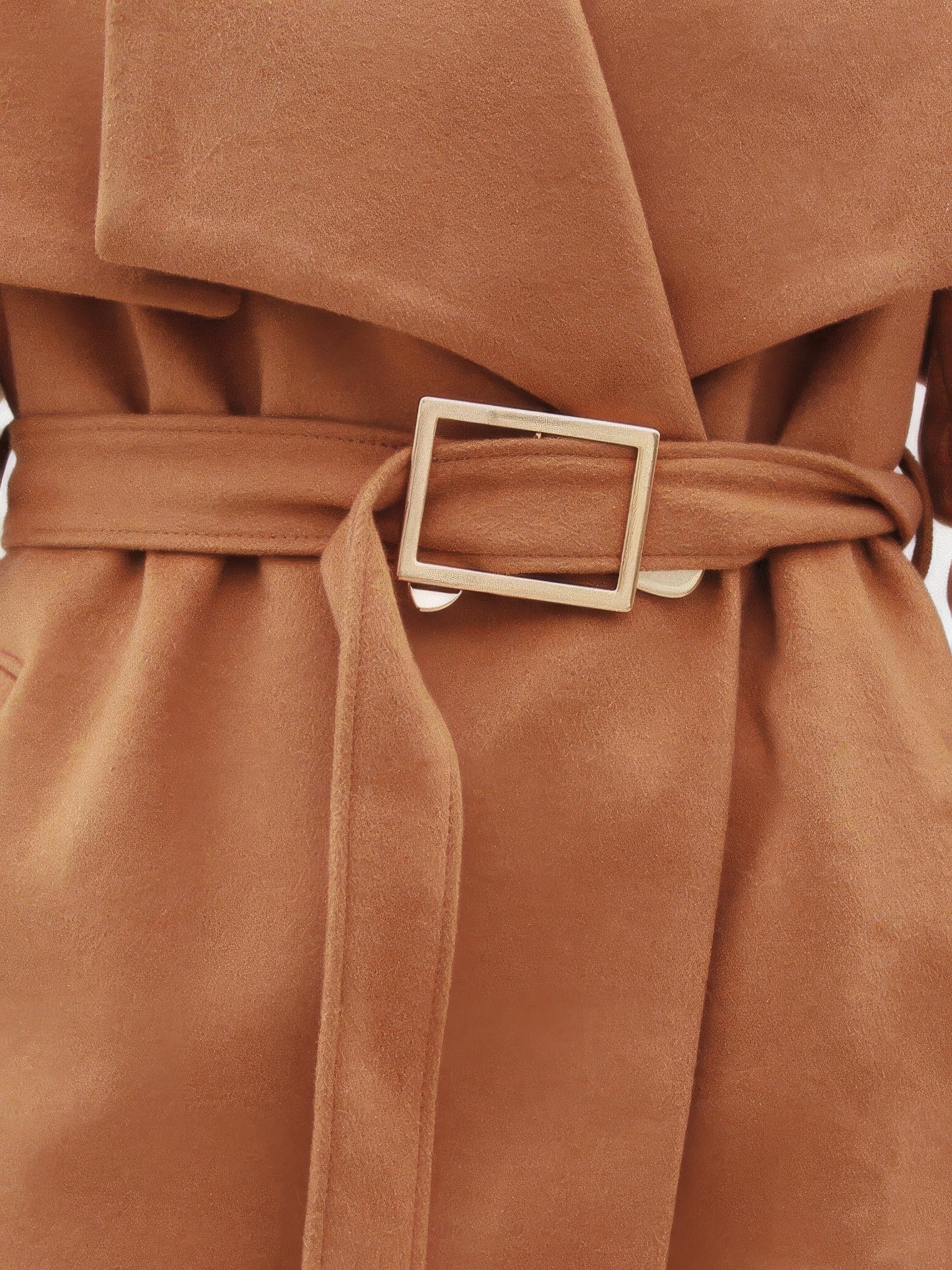 Close up of the self fabric belt and squared gold tone buckle on a camel wrap coat