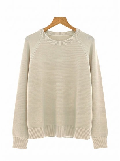 The Avington camel jumper in Calico on a wooden hanger
