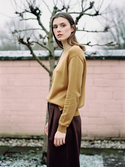The Avington camel jumper worn with chocolate brown wide leg trousers