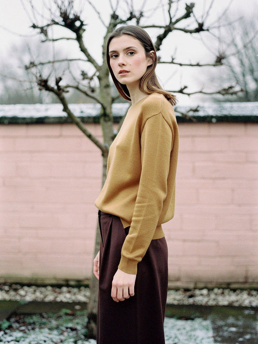 The Avington camel jumper worn with chocolate brown wide leg trousers