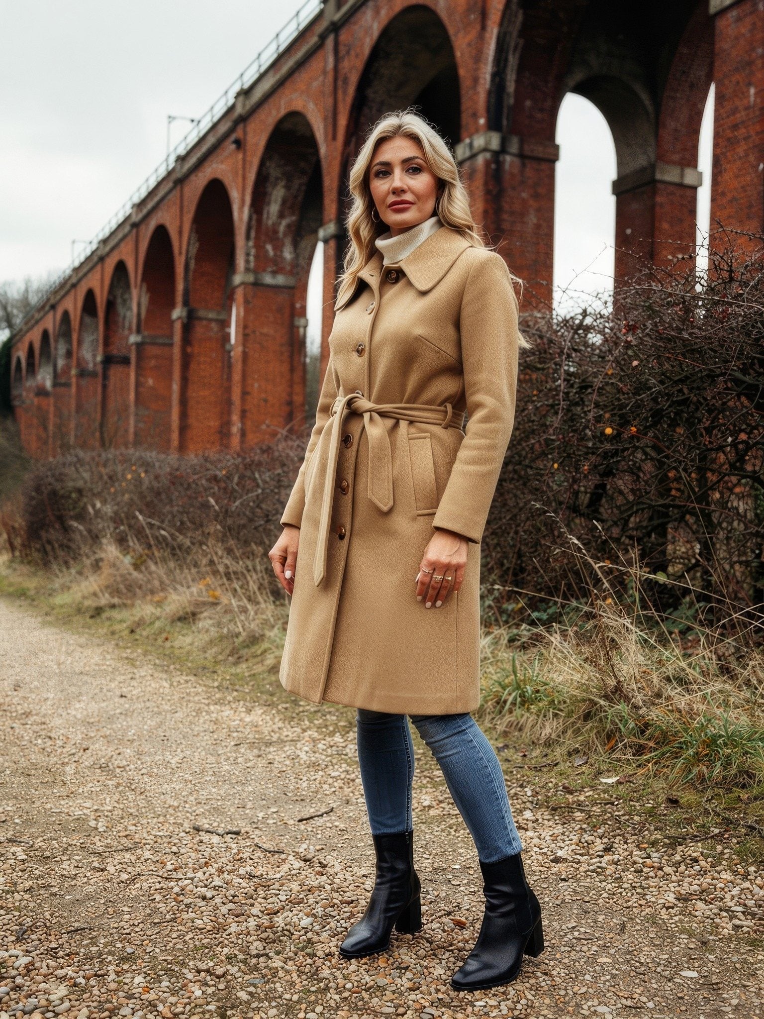 Womens camel overcoat in Caramel, single breasted and belted, worn full length