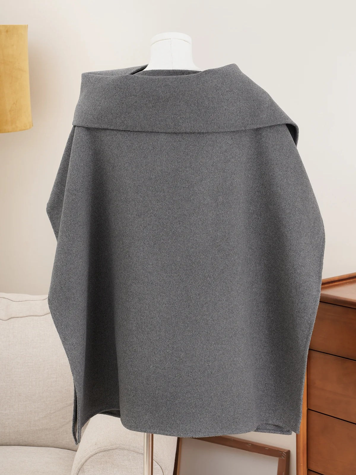Back of the cape coat in Zinc grey, showing the fold-back collar and the single back panel