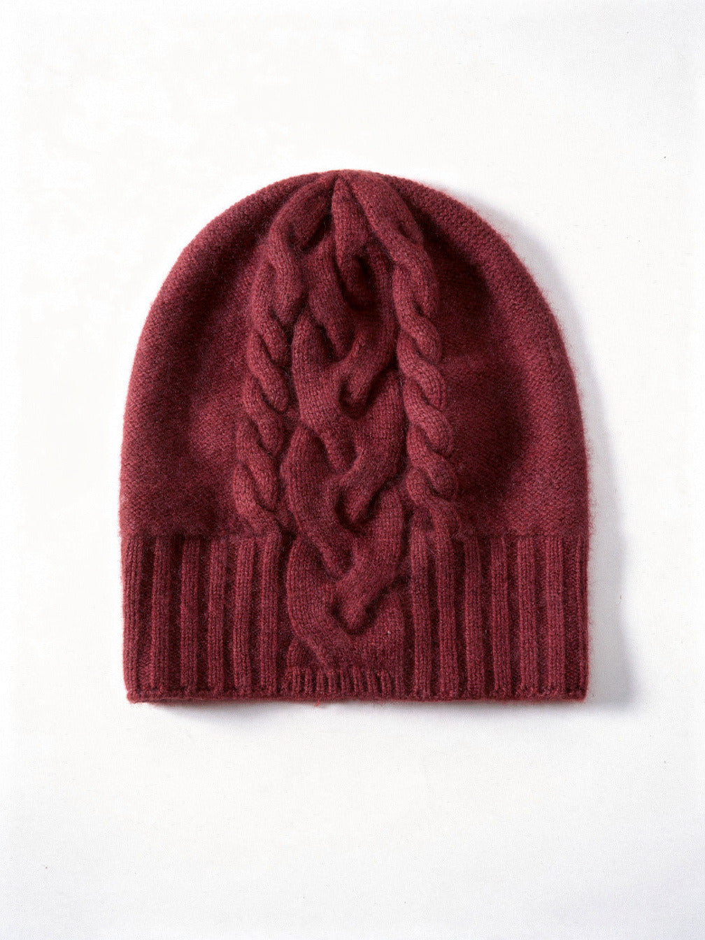 Burgundy cashmere hat with a plaited cable panel running down through the ribbed band