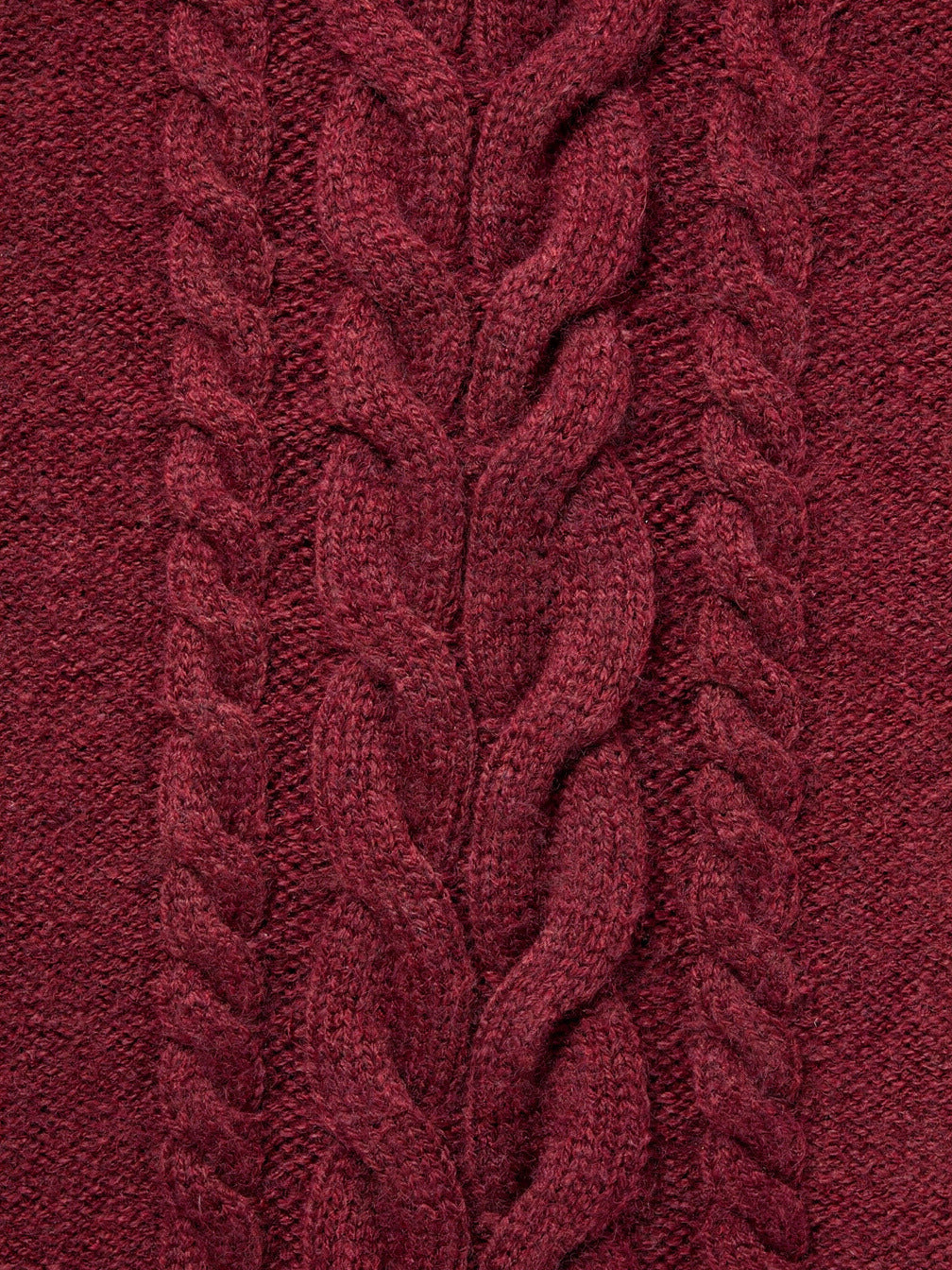 Close view of the plaited cable panel and rope twists on a burgundy cashmere hat