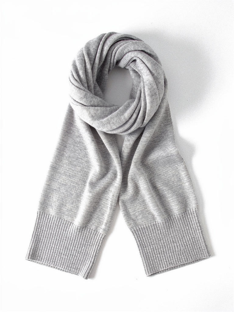 Oyster cashmere scarf laid flat and coiled on a white background