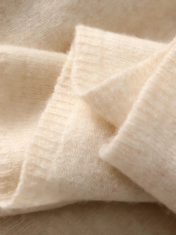 Close detail of the ribbed end band and brushed surface of the cashmere scarf