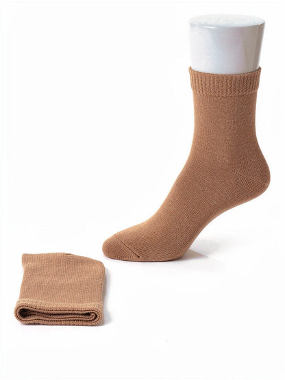 Cashmere socks in Biscuit, a warm mid-tan, shown as a pair