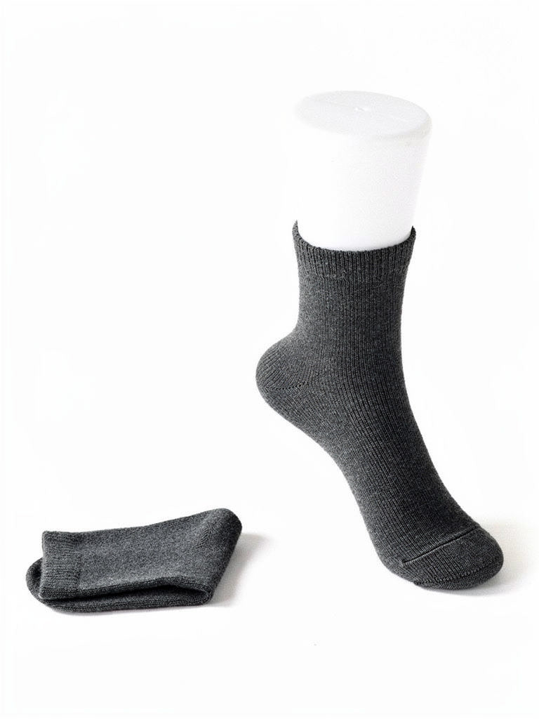 Cashmere socks in Charcoal, a deep neutral grey, shown as a pair