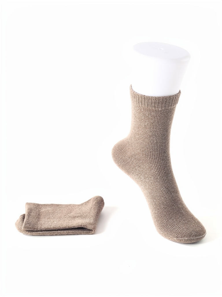 Cashmere socks in Mushroom, a pair shown on a display foot form and folded flat