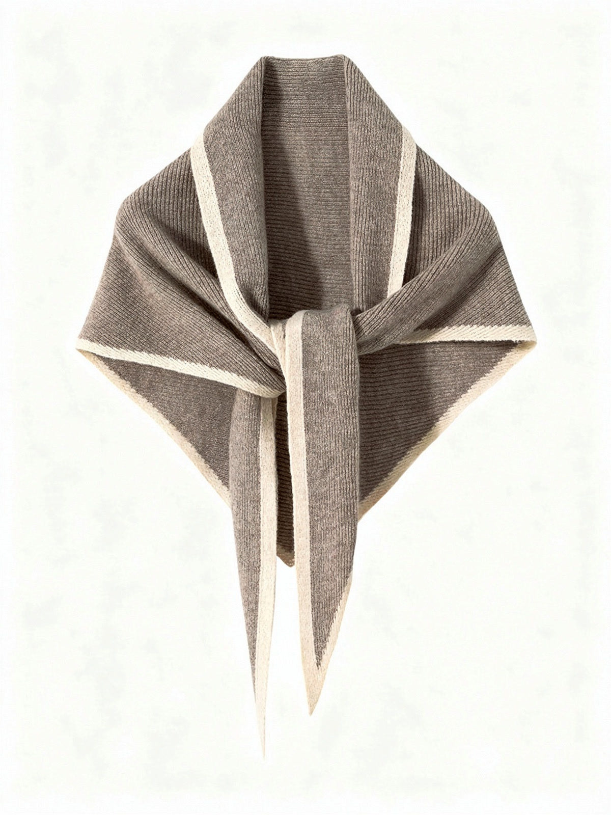 Cashmere triangle scarf in Clay, knotted, showing the knitted contrast edge
