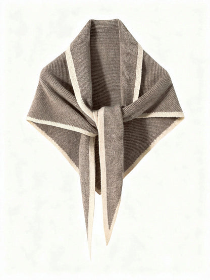 Cashmere triangle scarf in Clay, knotted, showing the knitted contrast edge