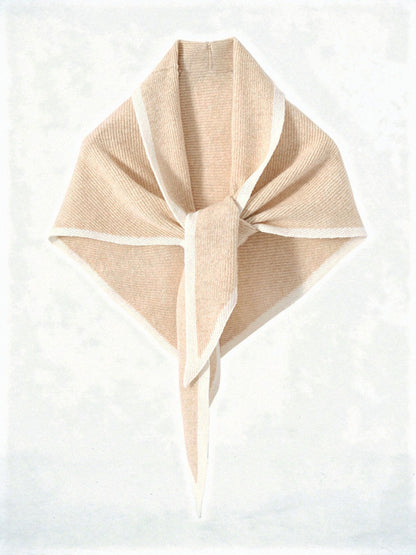 Cashmere triangle scarf in Hawthorn, knotted, showing the knitted contrast edge
