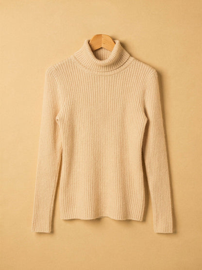Almond cashmere turtleneck jumper on a wooden hanger
