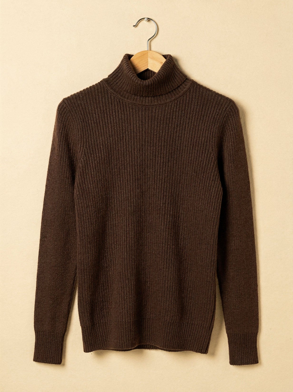 Espresso cashmere turtleneck jumper on a wooden hanger