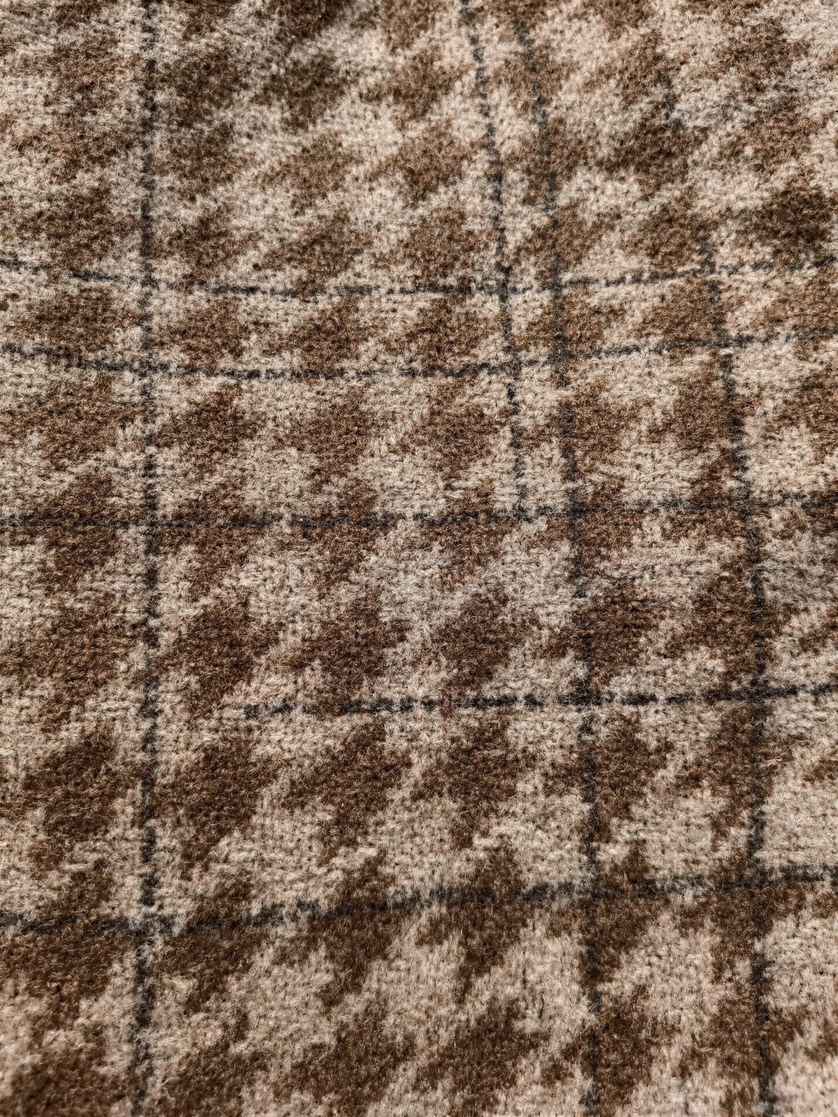 Close up of the brushed houndstooth check cloth with its faint wider overcheck