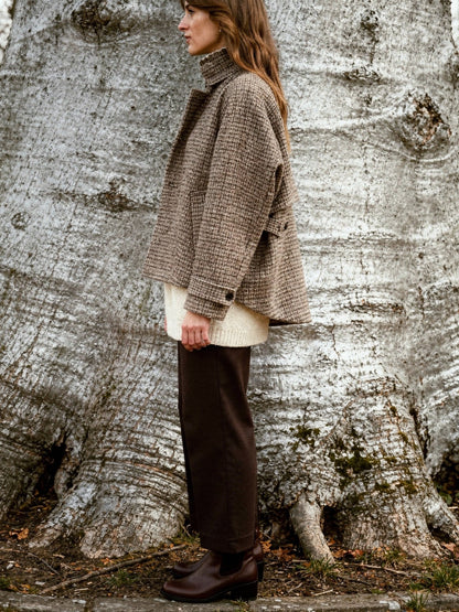 Check jacket in Russet houndstooth seen from the side, showing the short boxy cut and the buttoned tab at the cuff