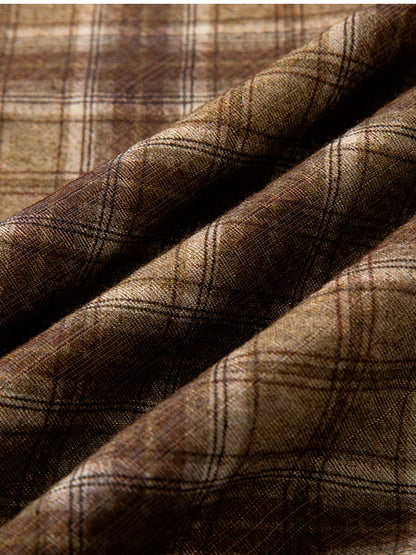 Close-up of the checked pleated skirt cloth, a soft camel and chocolate check on a fine flat weave