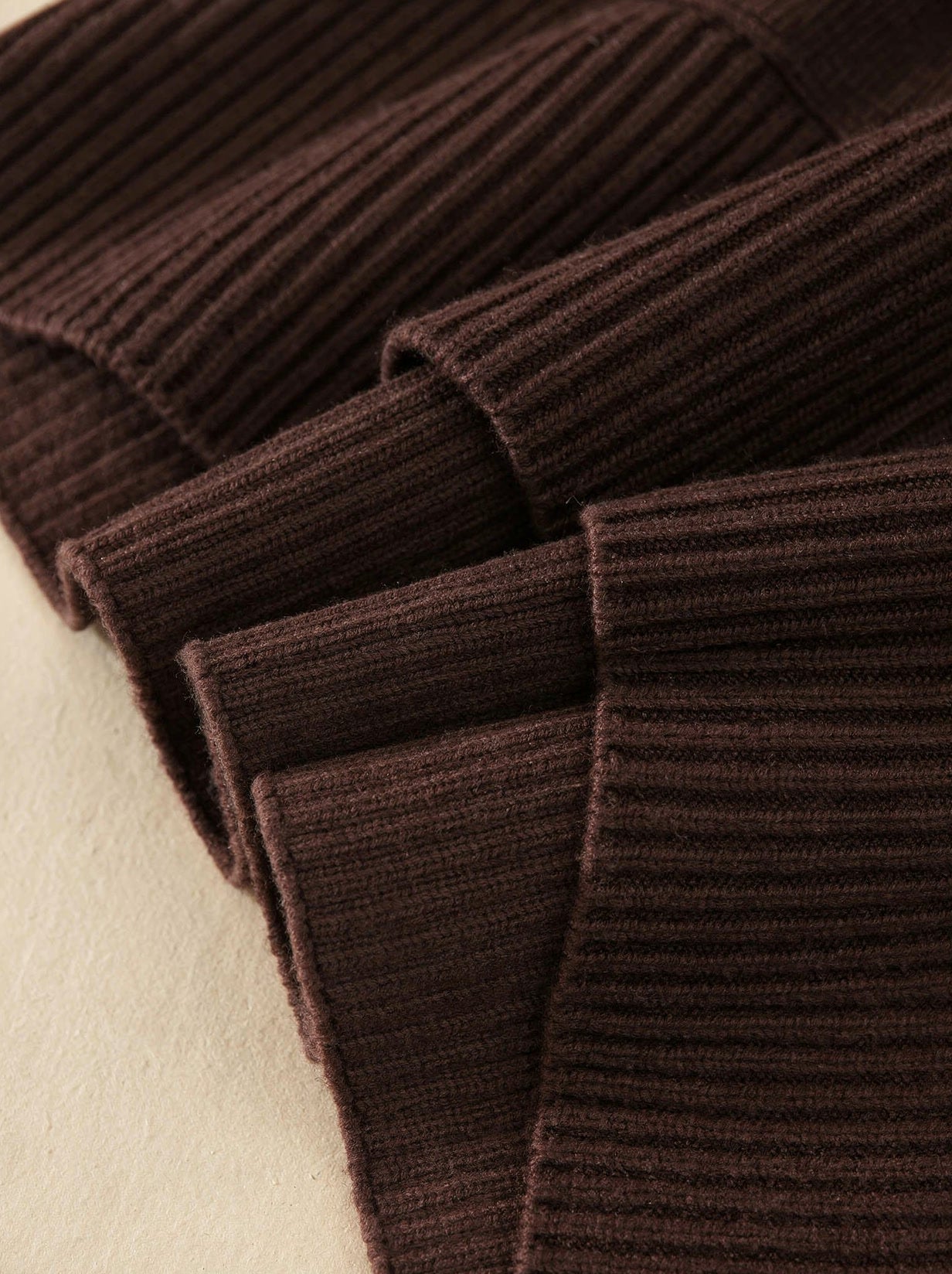Close-up of the chunky ribbed knit texture of the oversized roll neck jumper