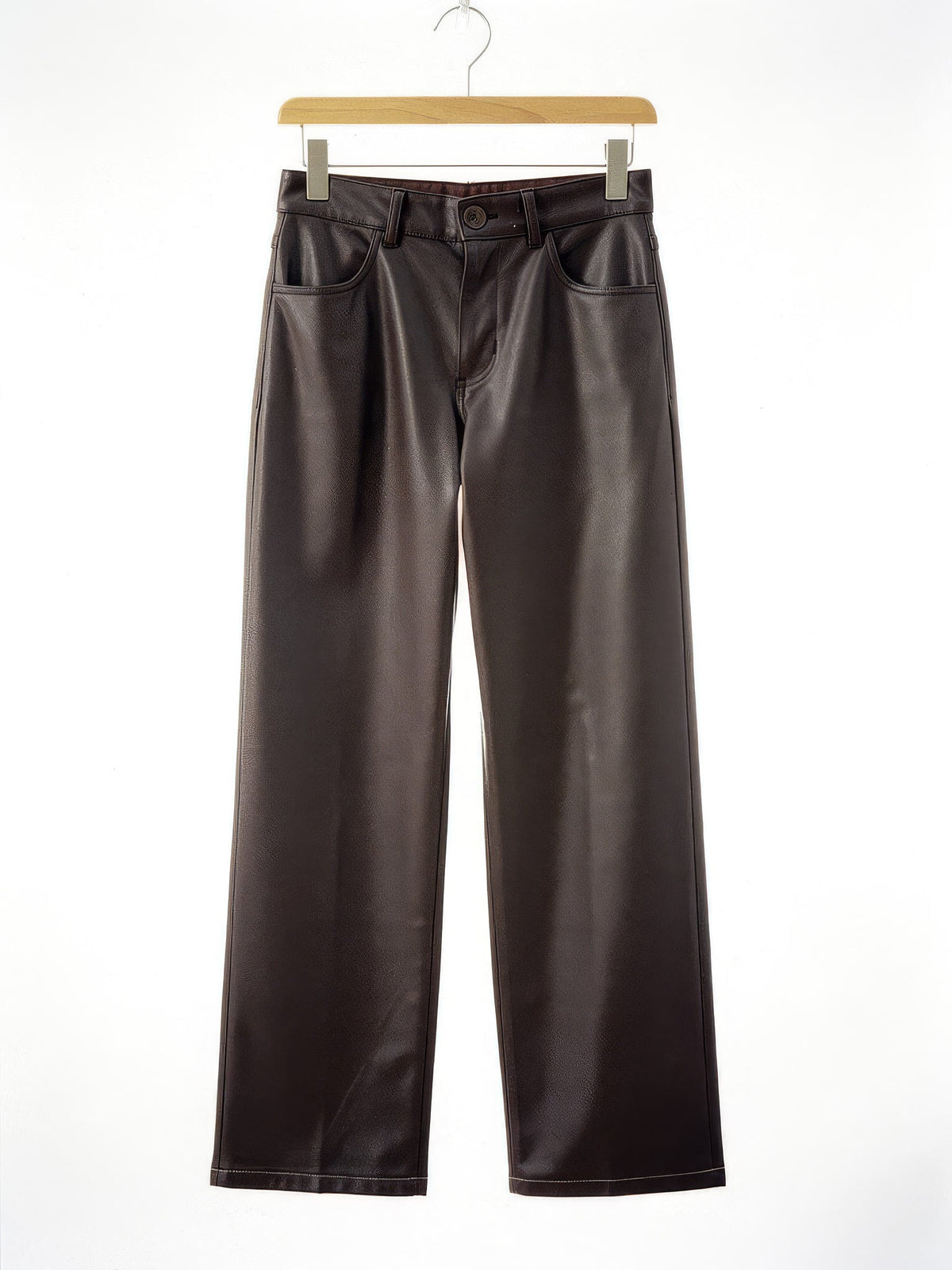 Coffee faux leather trousers, front view on a hanger