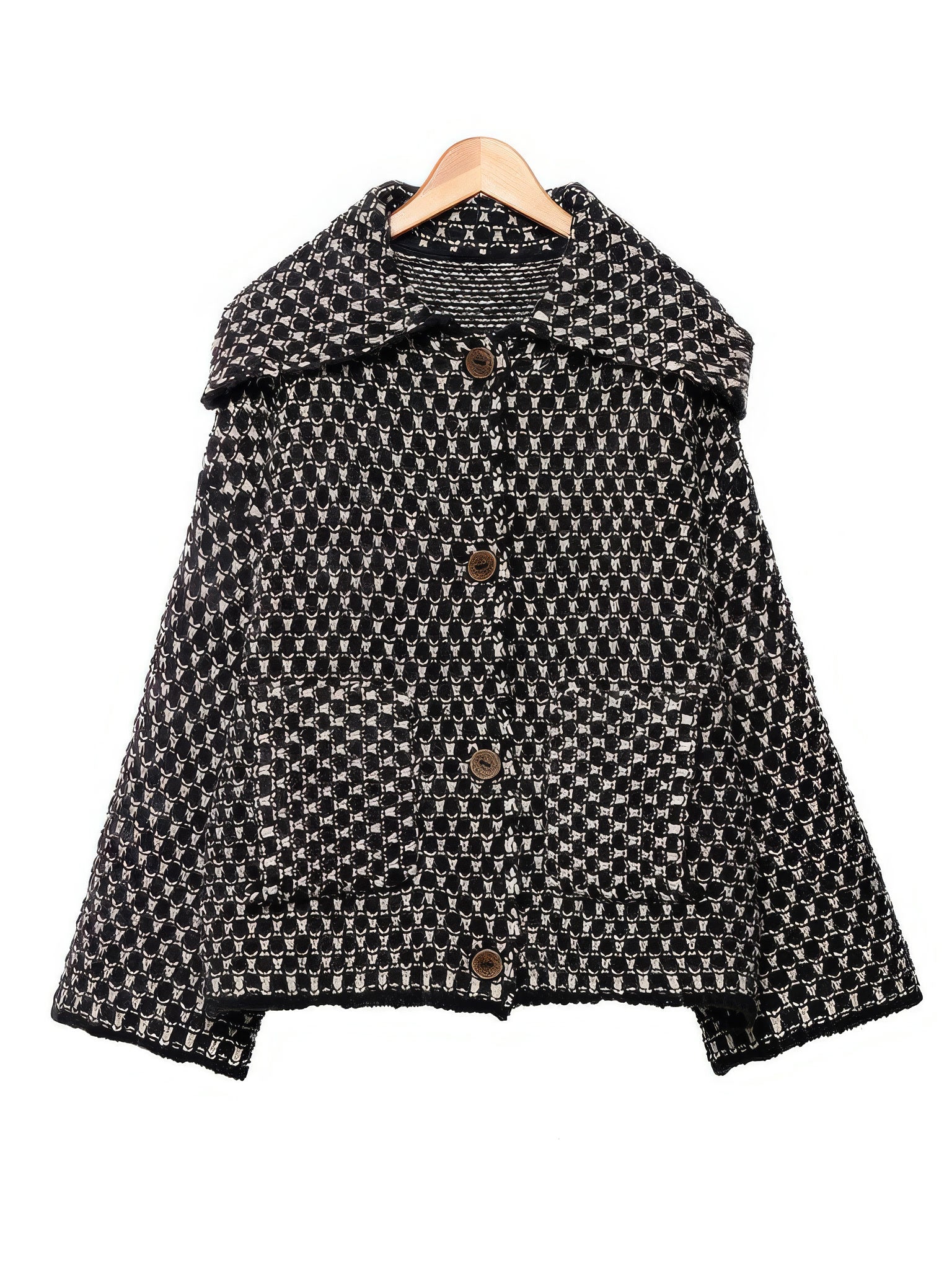 Black ecru collared cardigan in chunky two-tone knit on a wooden hanger