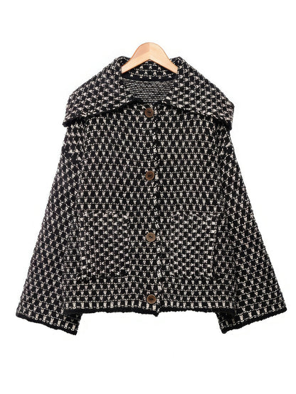 Black ecru collared cardigan in chunky two-tone knit on a wooden hanger