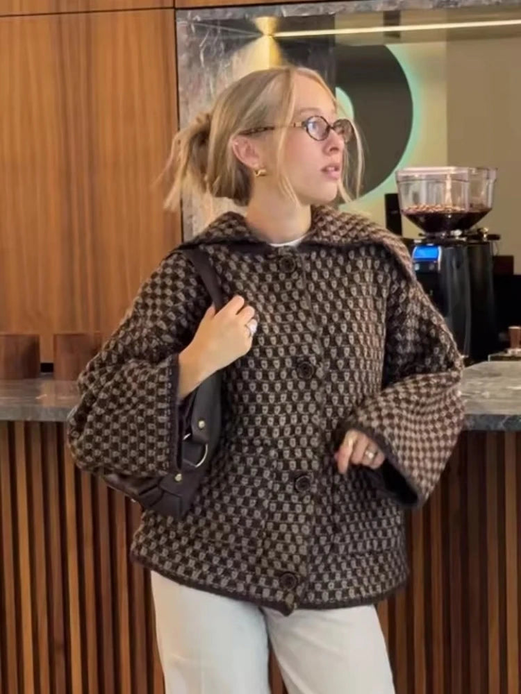 Cocoa brown collared cardigan worn open over a white shirt at a cafe table