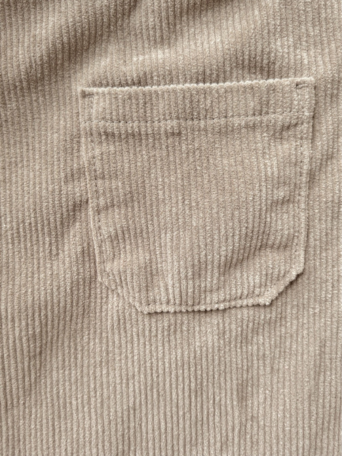 Close-up of the mid-wale corduroy and the stitched edge of a patch pocket