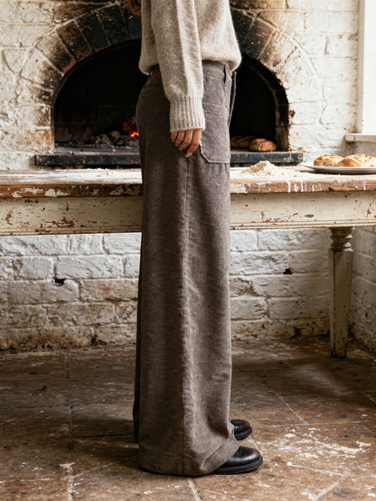 Side view of the Pinecone cord trousers, showing the wide leg breaking over a flat boot