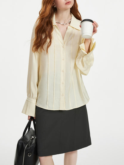 Womens cream blouse with a pintuck front, dropped shoulder and deep flared cuffs