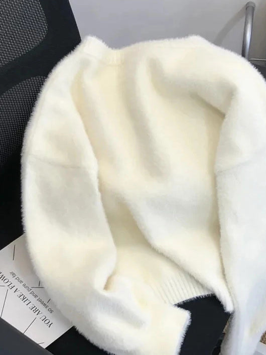 Back view of the cream fluffy cardigan showing the ribbed hem