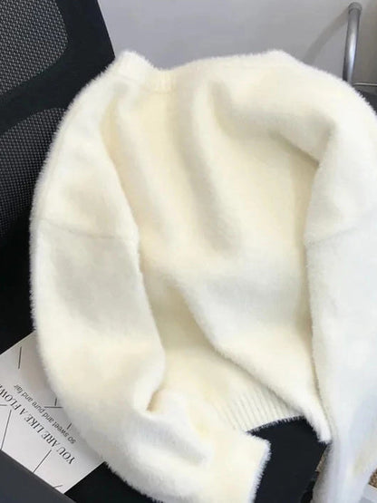 Back view of the cream fluffy cardigan showing the ribbed hem