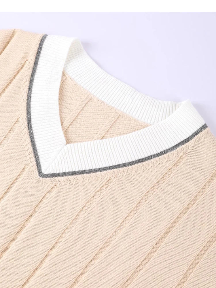 Close-up of the contrast-tipped ribbed V-neck collar of the cotton cricket jumper
