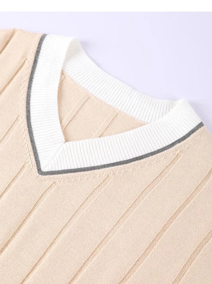 Close-up of the contrast-tipped ribbed V-neck collar of the cotton cricket jumper