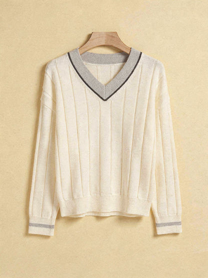 Ivory V-neck cricket jumper with pale grey contrast collar on a wooden hanger