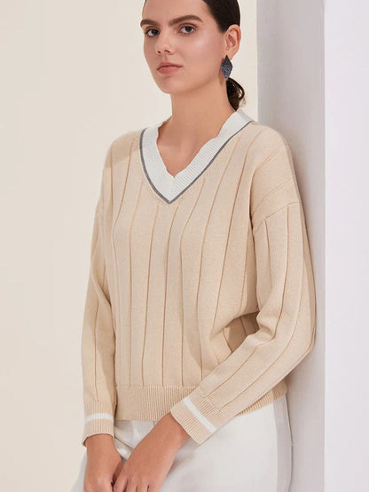 Detail of the stone cotton cricket jumper worn, showing wide flat ribs and striped cuffs