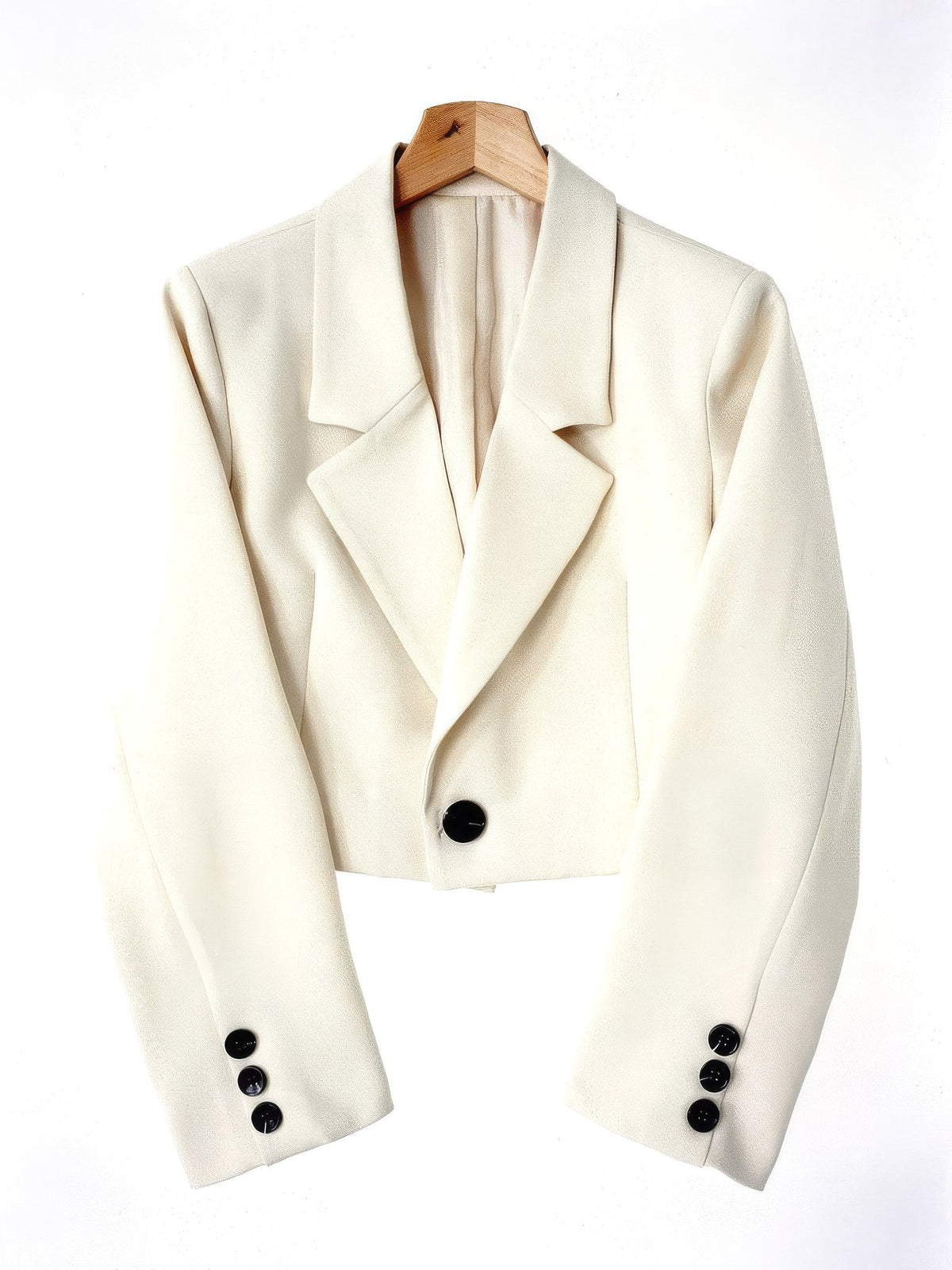 Cropped blazer in Bone ivory on a wooden hanger, front view