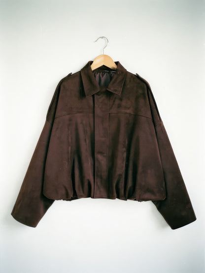 Chocolate brown cropped faux-suede jacket with batwing sleeves on a wooden hanger