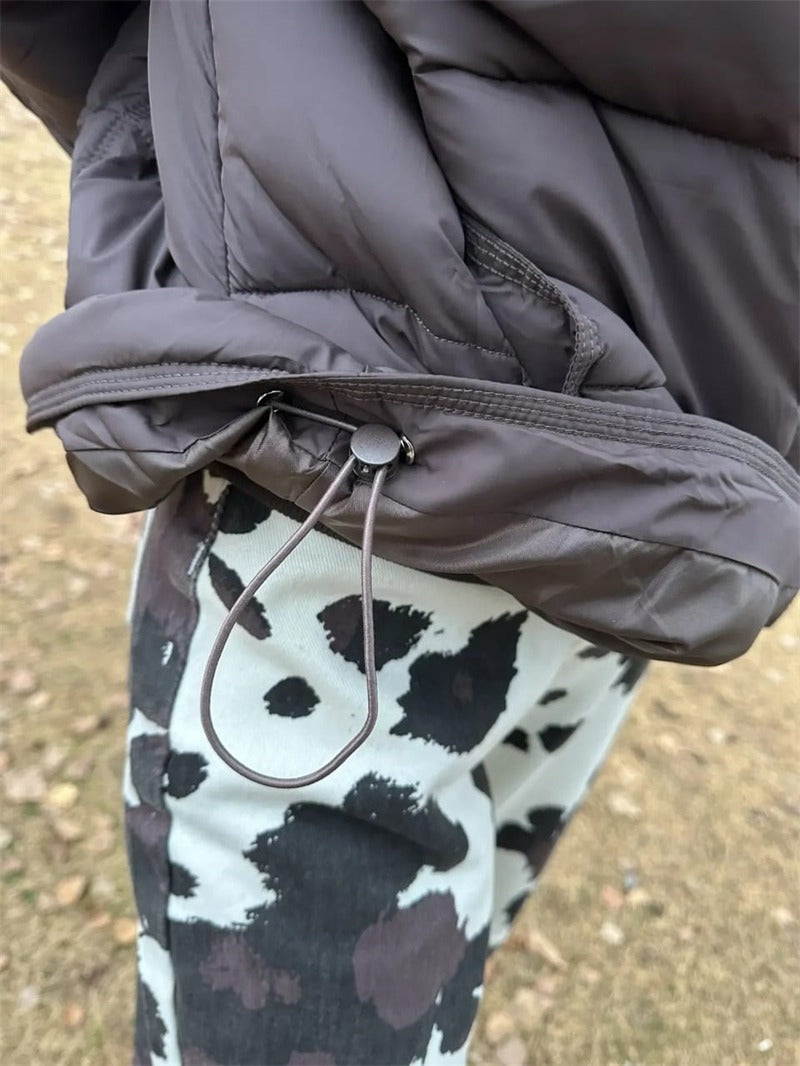 Close up of the drawcord hem and cord stopper on the cropped puffer jacket