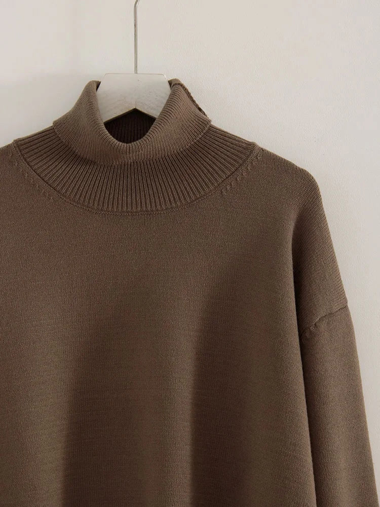 Close-up of the tall ribbed roll neck of the taupe cropped turtleneck jumper