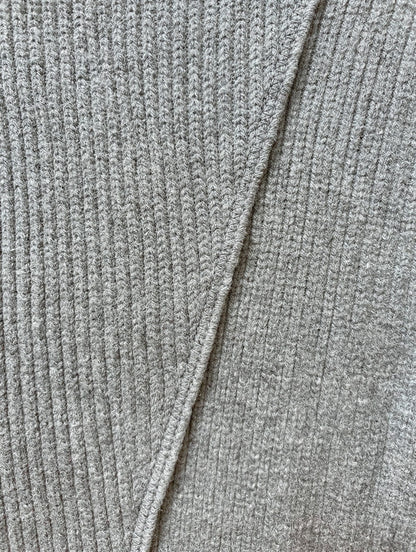 Close-up of the grey marl rib knit and crossover seam of the jumper dress