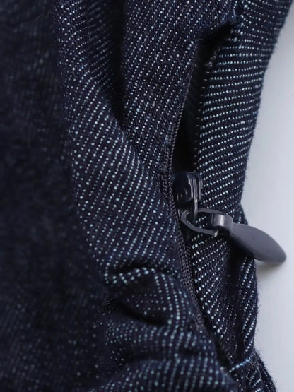Side seam zip and gathered waist of the denim dress