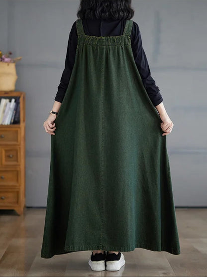 Back view of the denim pinafore dress, gathered back panel and plain straps